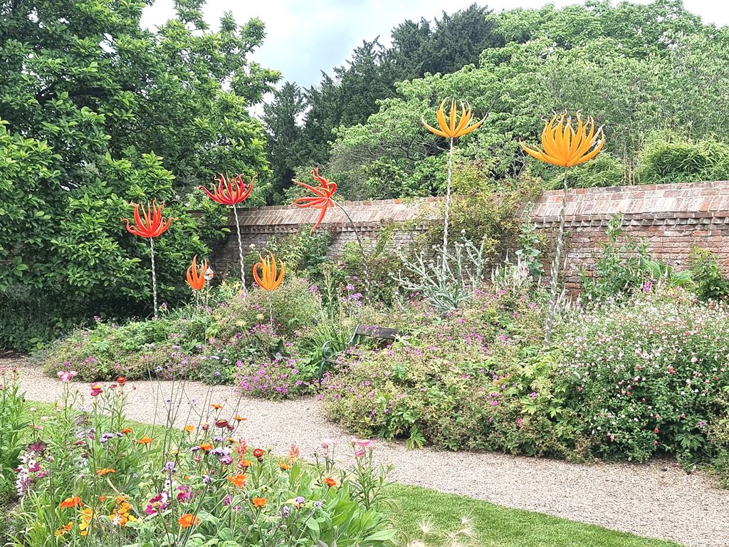 Oversized glass blooms in the flower beds - geograph.org.uk - 7830496